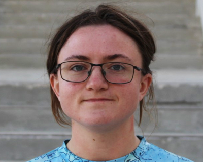 Picture of Lily Zimmerman standing against a background of stairs
